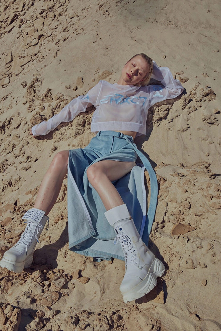 female model laying in sand