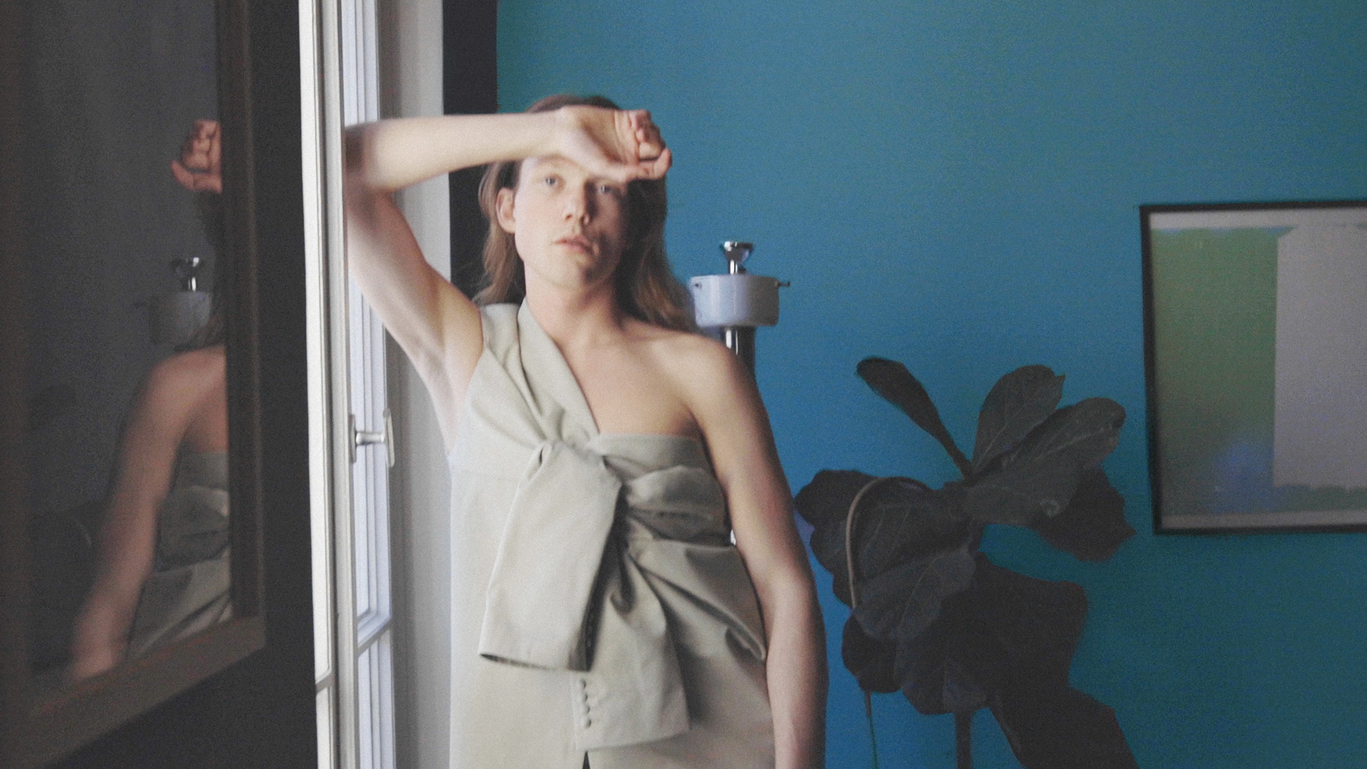 model sitting on top of arm chair