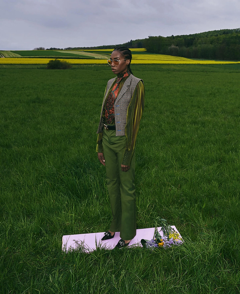 model stands in front of field