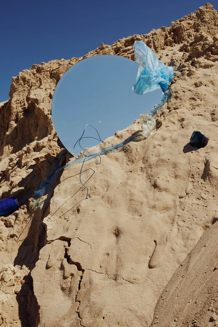 sand dune with round mirror